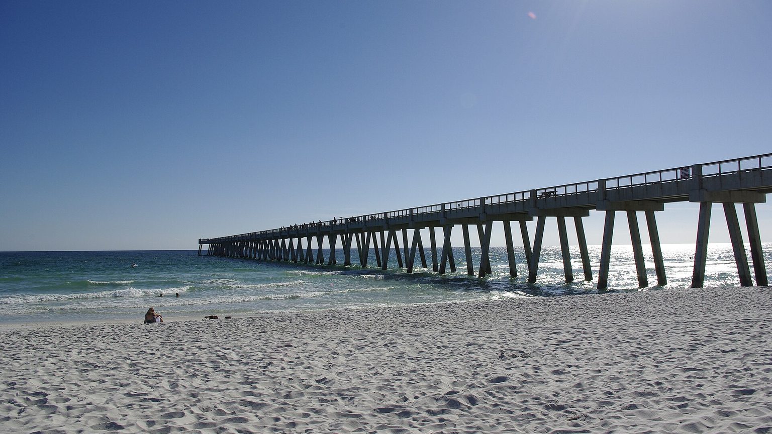 Navarre Beach Fishing Pier extending over emerald Gulf of Mexico water